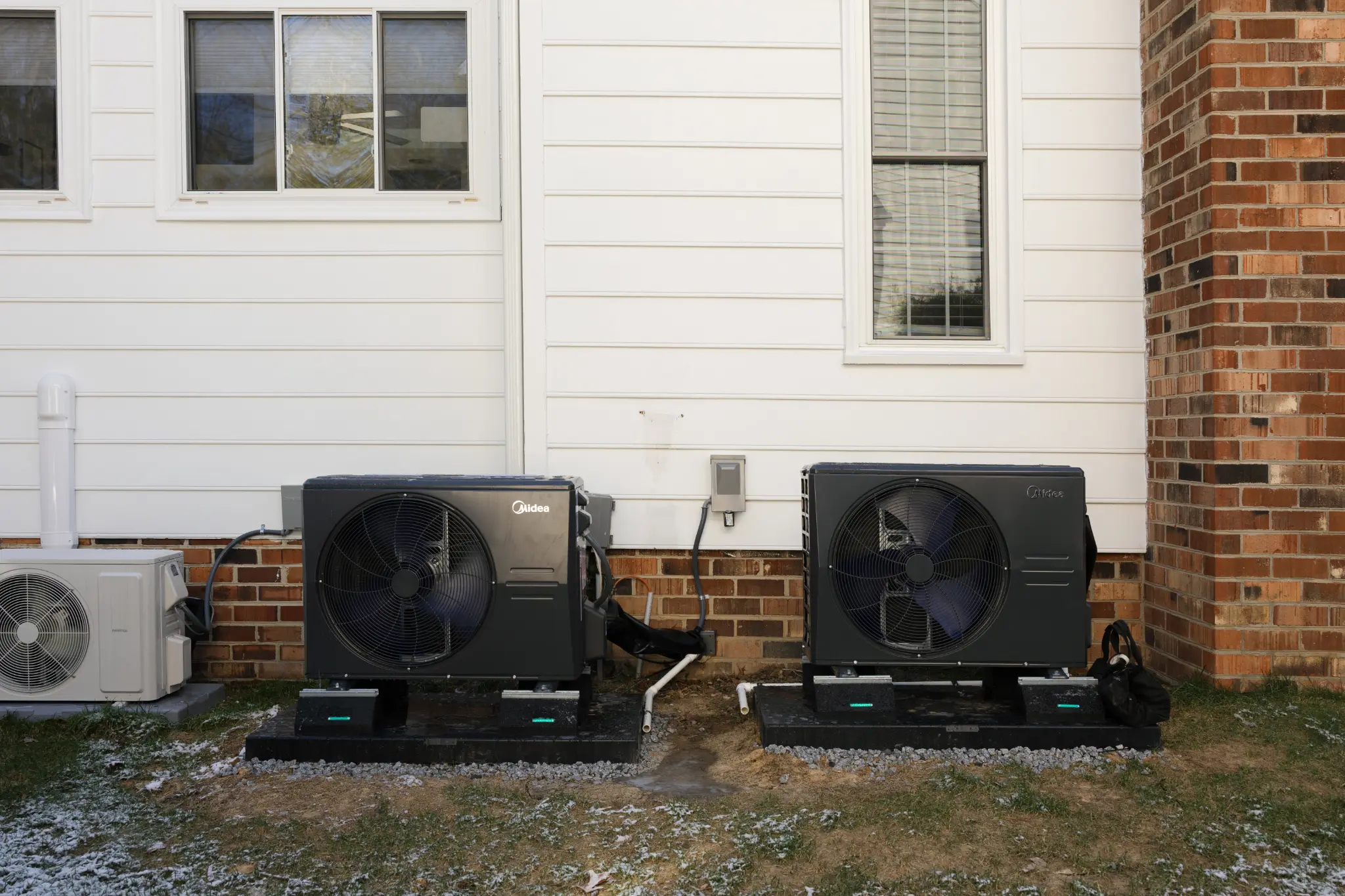 Technicians installing a heat pump